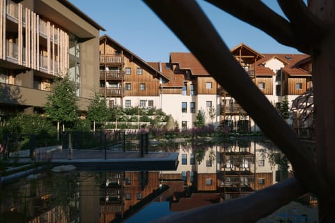 Die Hotelgebäude spiegeln sich im Teich der Gartenanlage